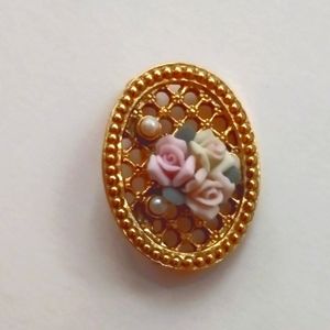 Oval goldtone rose porcelain brooch